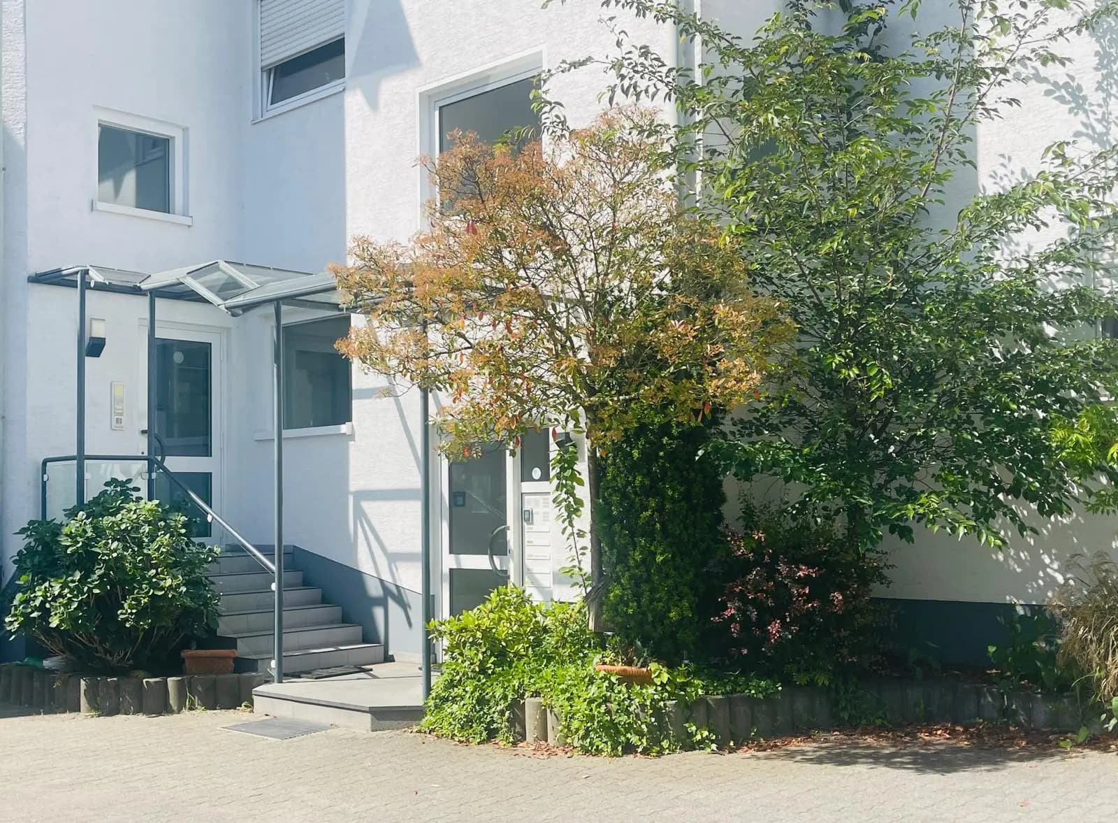 Exterior entrance of the TIMS school building with landscaped greenery